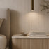 Bedroom with a Yunshan beige grey travertine-look BétonFlex flexible wall panel and a natural oak slat nightstand