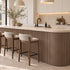 Rounded kitchen island covered in the walnut Mini slat SuperFlex flexible panel