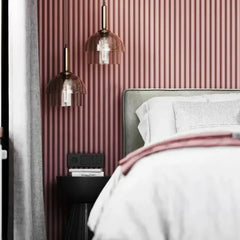 Linéapur Drum PVC wall panels painted powder pink behind a headboard